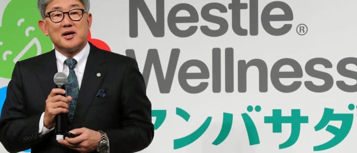 Nestle representative keeps a speech with the company logo in the background